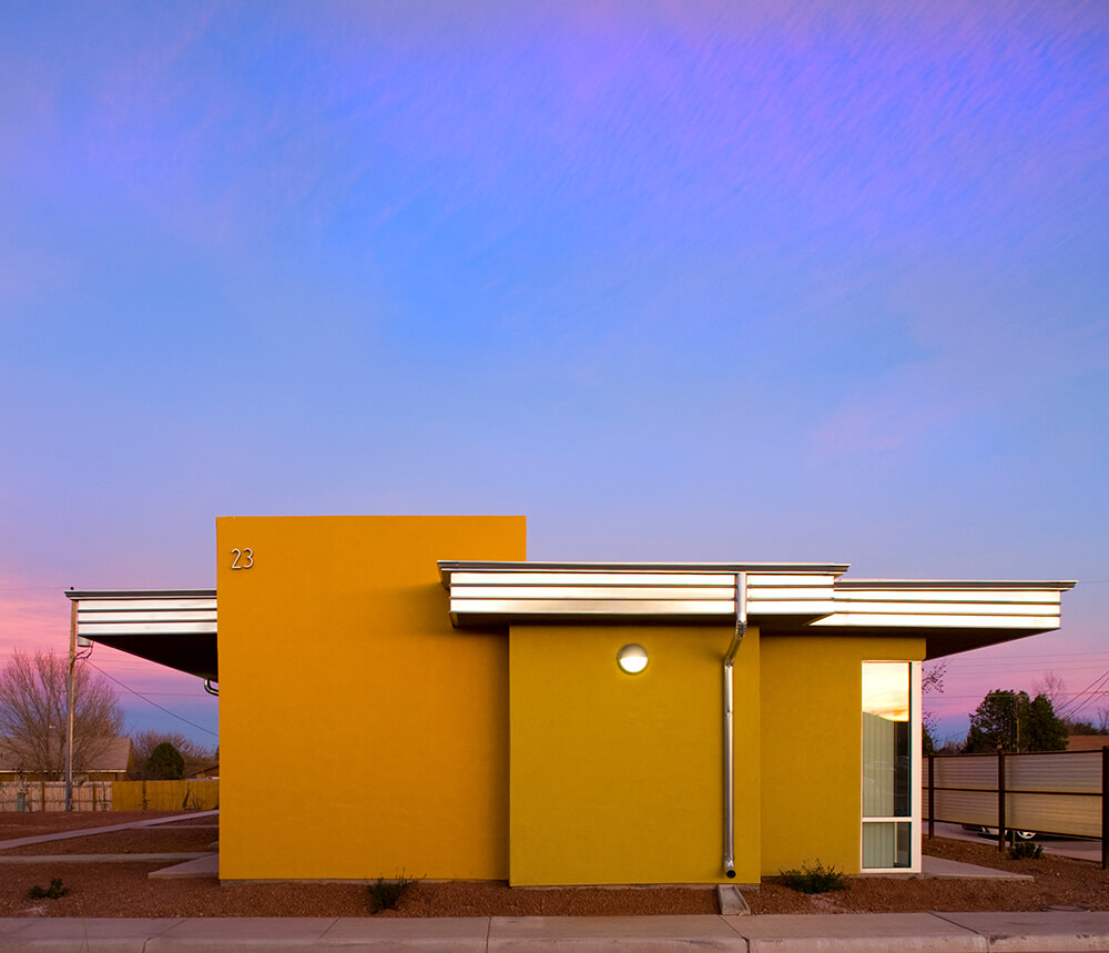 Single-story home at Wilshire Gardens under a pink and violet Pecos Valley sunset in Roswell